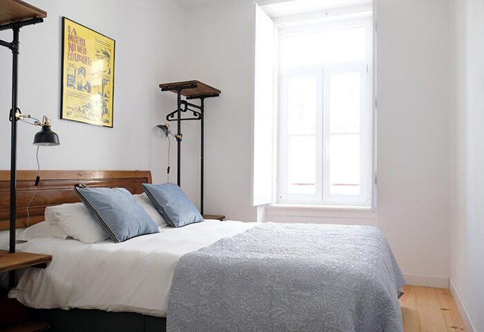 Lisbon Poets Inn Hostel room. Best gay hotel in Lisbon's gayborhood. Bright, clean room with double bed, vintage poster, and natural light.