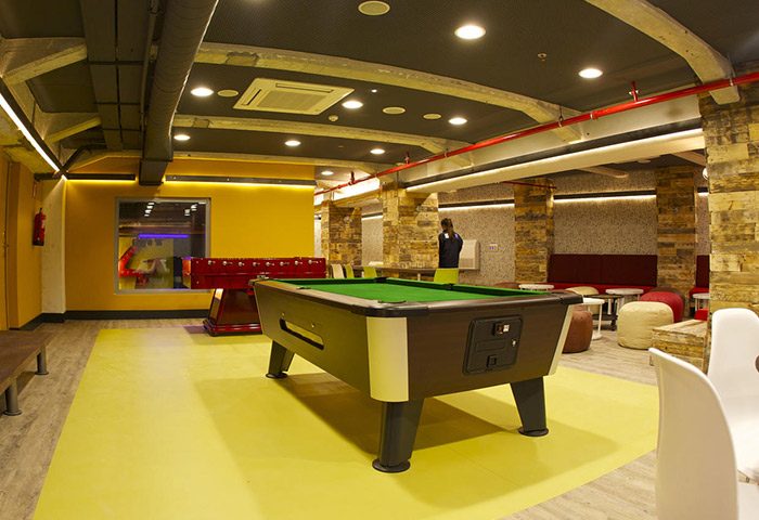 Generator Barcelona hotel game room. Pool table, foosball, and seating area. Best gay party hotels in Barcelona for gay men travel advice.