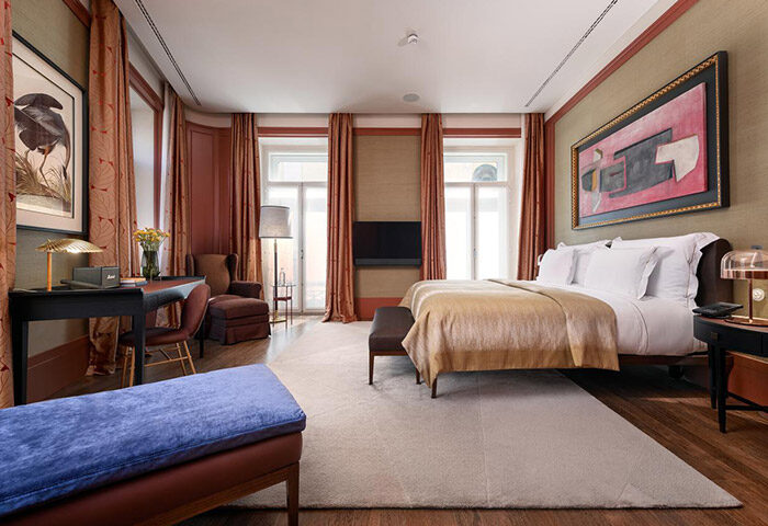 Bairro Alto Hotel honeymoon suite in Lisbon. Gay travel: bedroom with desk, bed, & sitting area. Best hotel ideas in Central Lisbon.