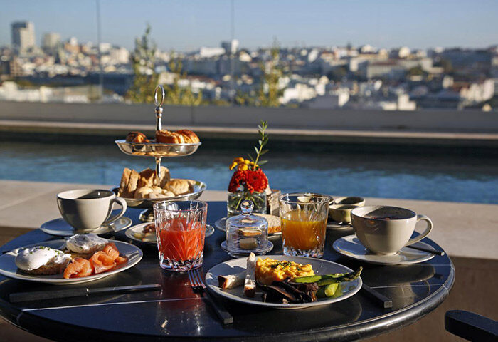 Breakfast at Memmo Principe Real Design Hotel, Lisbon. Rooftop swimming pool view. Luxury gay hotel. Smoked salmon, pastries, coffee.