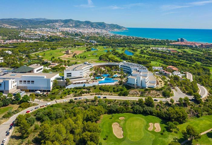 Dolce by Wyndham Sitges aerial view. Gay-friendly luxury hotel near the gay beach, perfect for a honeymoon. Golf course and coastal views.