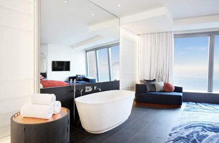 W Barcelona hotel bathroom suite. A luxury honeymoon hotel for gay couples. Modern design with bathtub and ocean view. Best hotels.