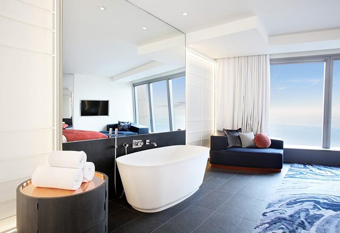 W Barcelona hotel bathroom suite. A luxury honeymoon hotel for gay couples. Modern design with bathtub and ocean view. Best hotels.