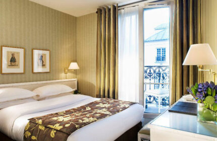Hotel Turenne Le Marais room. Best opening gay hotel Paris city center. Balcony view, floral accents, and inviting bed.