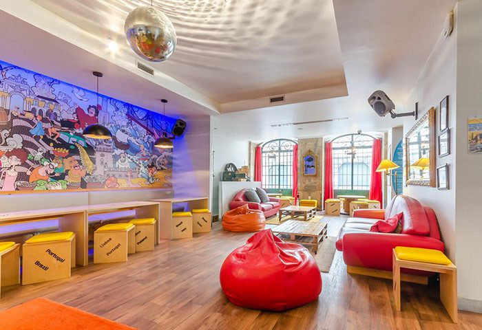 Yes! Lisbon Hostel's party area. This gay-friendly hostel in Lisbon, Portugal, has a disco ball, colorful mural, and comfy seating.