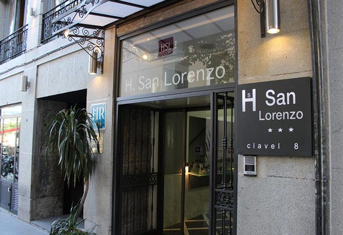 Hostal San Lorenzo entrance in Madrid's Chueca gayborhood. Best party hostel for gay travelers. Clavel 8 address sign. Three-star rating.