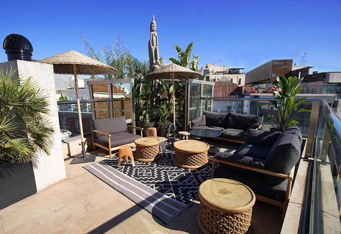 Urban Hotel rooftop bar in Madrid city center. This gay-friendly hotel on Gran Via features stylish outdoor seating and city views.
