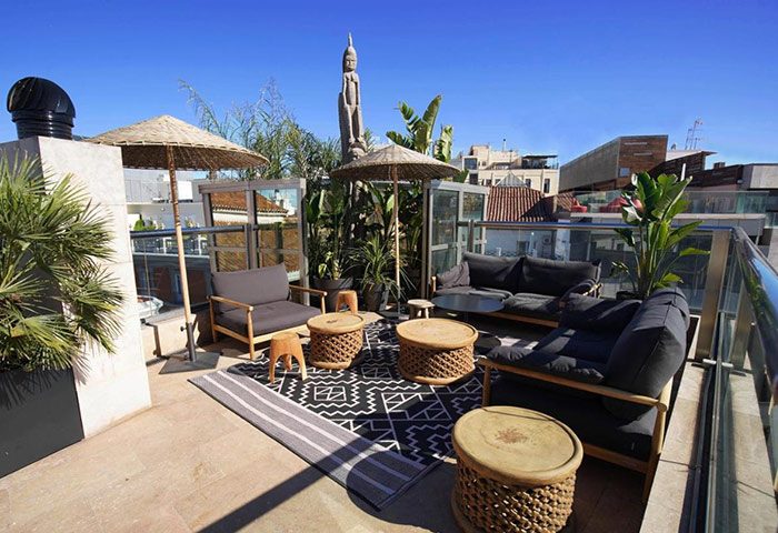 Urban Hotel rooftop bar in Madrid city center. This gay-friendly hotel on Gran Via features stylish outdoor seating and city views.