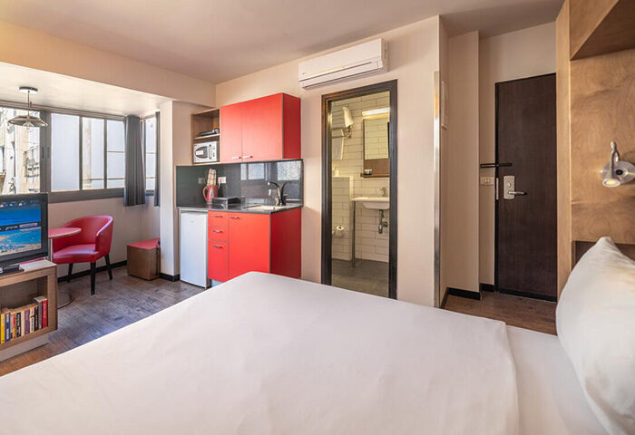 Ben Yehuda Apartments, Tel Aviv. Service apartment penthouse interior near Hilton Beach in the Gayborhood. Room with kitchenette and bathroom.
