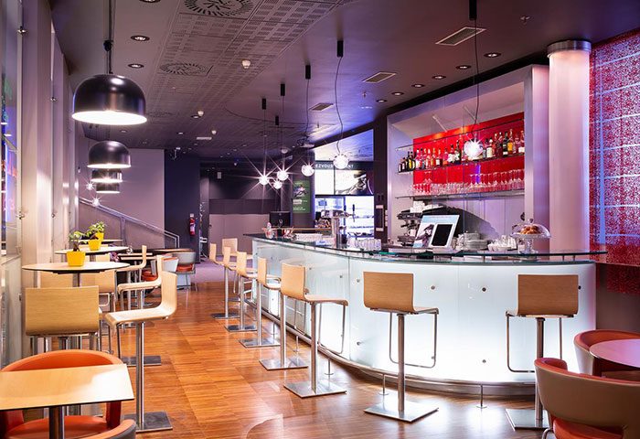 Ibis Praha Old Town Hotel's bar area. Modern design with bar stools, tables, and a well-stocked bar. Gay-friendly hotel in Prague.