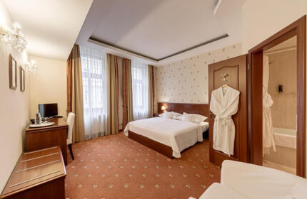 Louren Hotel room in Prague's Gayborhood Vinohrady. Gay honeymoon hotels feature a bed, desk, & bathroom. Perfect for gay couples.