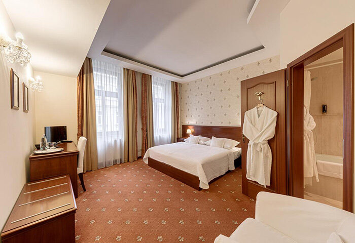 Louren Hotel room in Prague's Gayborhood Vinohrady. Gay honeymoon hotels feature a bed, desk, & bathroom. Perfect for gay couples.