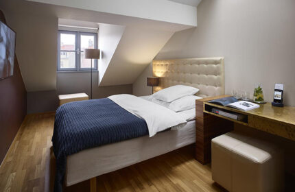 The Icon Hotel and Lounge, Prague. Gay hotel city center room with bed, desk, and window. Modern design, comfortable for gay travelers.
