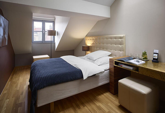 The Icon Hotel and Lounge, Prague. Gay hotel city center room with bed, desk, and window. Modern design, comfortable for gay travelers.