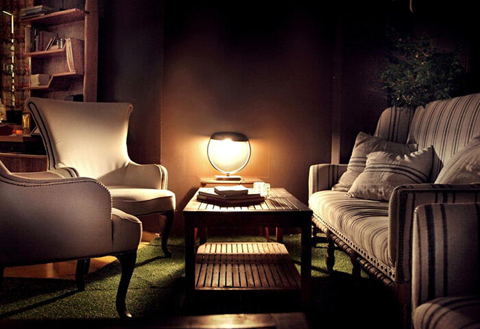 Brown TLV Hotel's lounge area in Tel Aviv. Cozy seating with armchairs and a striped sofa. Gay-owned hotel, most booked for gay travelers.