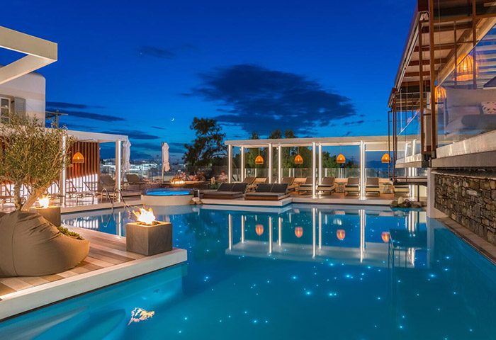 Semeli Hotel Mykonos pool at night. Popular gay honeymoon hotel in Mykonos Town city center. Luxury travel destination for gay men.
