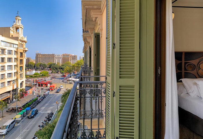 View from H10 Metropolitan Hotel, a stylish gay hotel in Barcelona near gay clubs. Balcony overlooks a bustling city square.