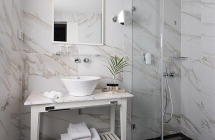 Stylish bathroom at Melody Hotel, a gay hotel in Tel Aviv near Hilton Gay Beach. Marble tiles, modern sink, and shower. City Center.
