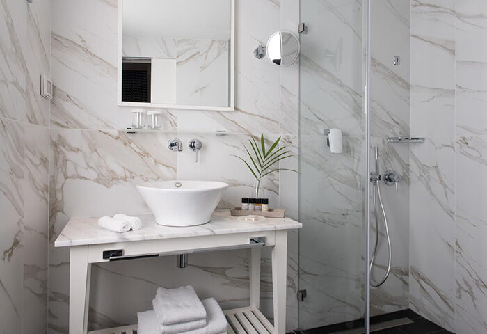 Stylish bathroom at Melody Hotel, a gay hotel in Tel Aviv near Hilton Gay Beach. Marble tiles, modern sink, and shower. City Center.