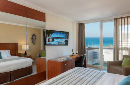 Herods Tel Aviv By the Beach: Gay hotel room with pool view. Beachfront property for gay travelers. Modern design, balcony, and sea view.