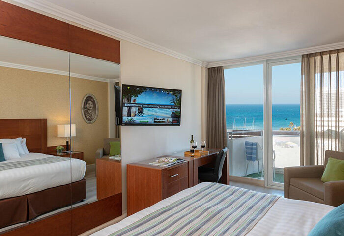 Herods Tel Aviv By the Beach: Gay hotel room with pool view. Beachfront property for gay travelers. Modern design, balcony, and sea view.