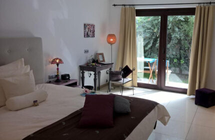Birdcage Gay Men Resort bedroom with patio view. Gran Canaria gay hotel near Yumbo Center nightlife. Lifestyle hotel room interior.