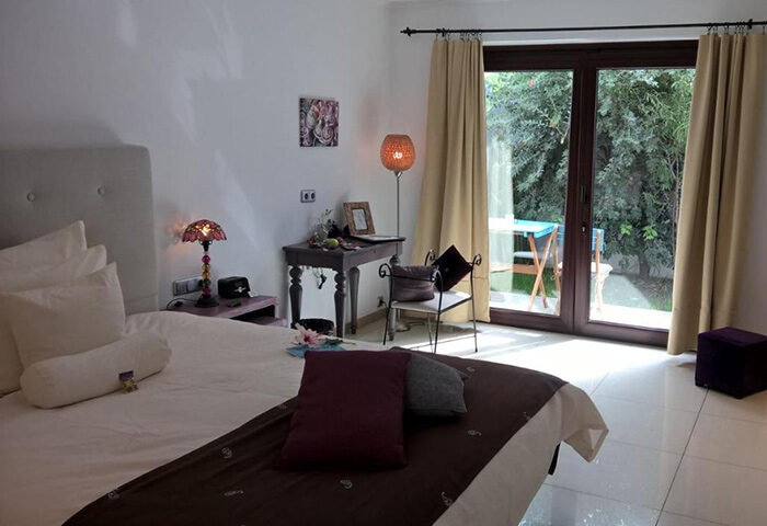 Birdcage Gay Men Resort bedroom with patio view. Gran Canaria gay hotel near Yumbo Center nightlife. Lifestyle hotel room interior.