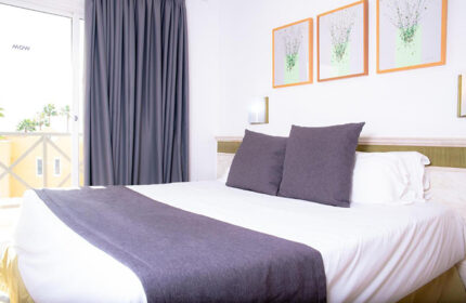 Vista Bonita Gay Only Resort room. Modern gay hotel in Maspalomas, Gran Canaria. Features bed, balcony, and stylish decor. Gay nightlife nearby.