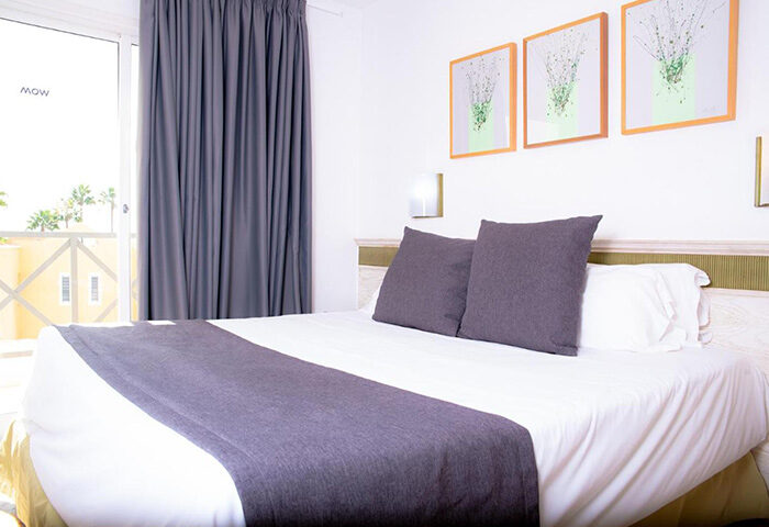 Vista Bonita Gay Only Resort room. Modern gay hotel in Maspalomas, Gran Canaria. Features bed, balcony, and stylish decor. Gay nightlife nearby.