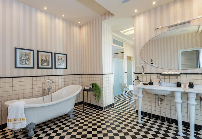 Herods Tel Aviv bathroom. Honeymoon hotel idea in Hilton Beach Gayborhood. Clawfoot tub, black and white tile. Gay travel advice.
