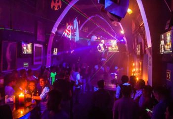Tom's Leather Bar: Gay party in Mexico with drinks, purple lights, and people dancing. Gay travel advice in Puerto Vallarta.