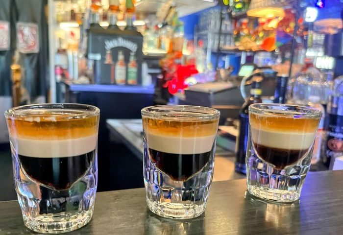 Tool Shed Drinks: Three layered shot glasses on a bar. The Tool Shed is a popular gay bar. Drinks are a must when traveling!