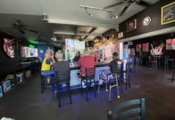 Tool Shed bar experience: Interior view of the gay bar with patrons at the bar. A popular travel destination for gay men.