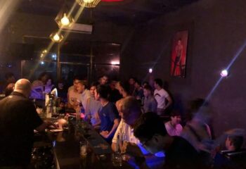Busy ToolBox Bar in Phnom Penh. Gay bar scene with many men at the bar, enjoying drinks and socializing. Nightlife in Cambodia.