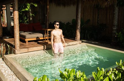 Gay honeymoon: Man in private pool at Anantara Rasananda Koh Phangan Villa. Best villa for gay couples. Thailand luxury travel.