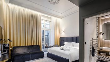 Hotel Century Old Town Prague MGallery room. Gay honeymoon suite with bed, sofa, and bathroom. Luxury Prague hotel for gay travelers.