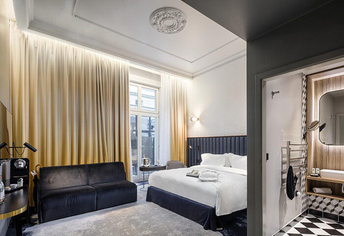 Hotel Century Old Town Prague MGallery room. Gay honeymoon suite with bed, sofa, and bathroom. Luxury Prague hotel for gay travelers.