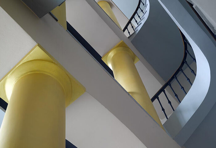 Staircase detail at The Icon Hotel and Lounge, Prague. Instagram-perfect design with golden columns, a top gay hotel. Interior architecture.