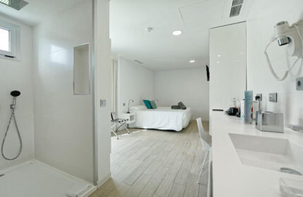 Seven Hotel & Wellness, gay men only. Modern room interior, Gran Canaria hotel. Top choice for first-time gay visitors. All-white design.