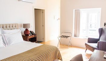 Monte Belvedere Hotel by Shiadu room. Lisbon gay hotel near gay sauna. Top cool design, cheap hotel room. Bed, chair, luggage rack.