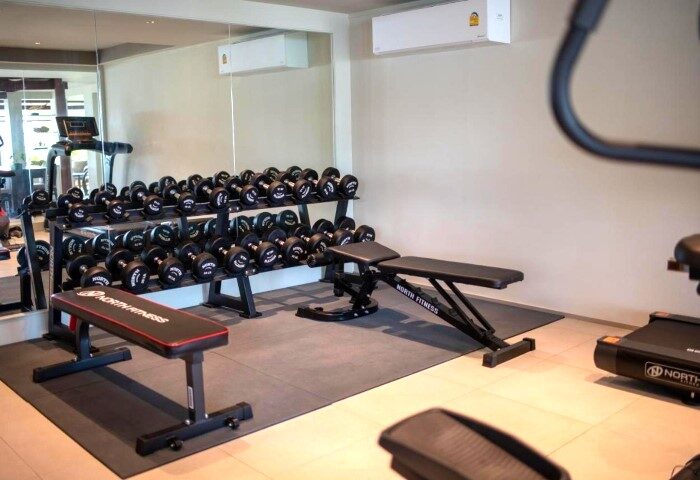 Rocky's Boutique Resort fitness center, Koh Samui. Dumbbells, benches, and treadmills offer a wellness experience at this gay beach resort.