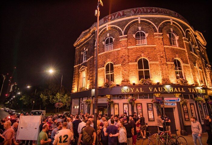 Royal Vauxhall Tavern (RVT), a top gay bar in London. Crowd outside this iconic venue known for its drag shows and vibrant atmosphere.