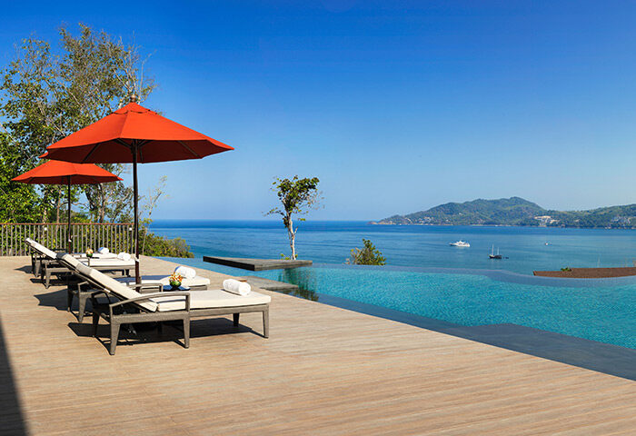 Amari Phuket, Thailand beachfront hotel near Patong. Infinity pool, loungers, and ocean view. Top gay travel destination.