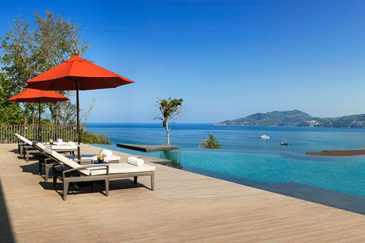 Amari Phuket, Thailand beachfront hotel near Patong. Infinity pool, loungers, and ocean view. Top gay travel destination.