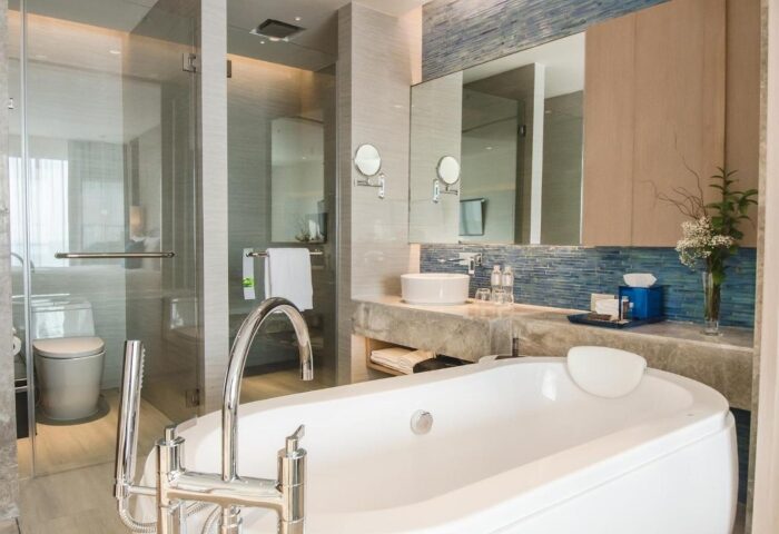 Renaissance Pattaya Resort & Spa bathroom. Gay-friendly beachfront hotel. Bathtub, shower, sink, & mirror in a modern design. Gay travel.