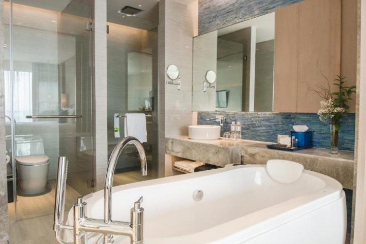 Renaissance Pattaya Resort & Spa bathroom. Gay-friendly beachfront hotel. Bathtub, shower, sink, & mirror in a modern design. Gay travel.