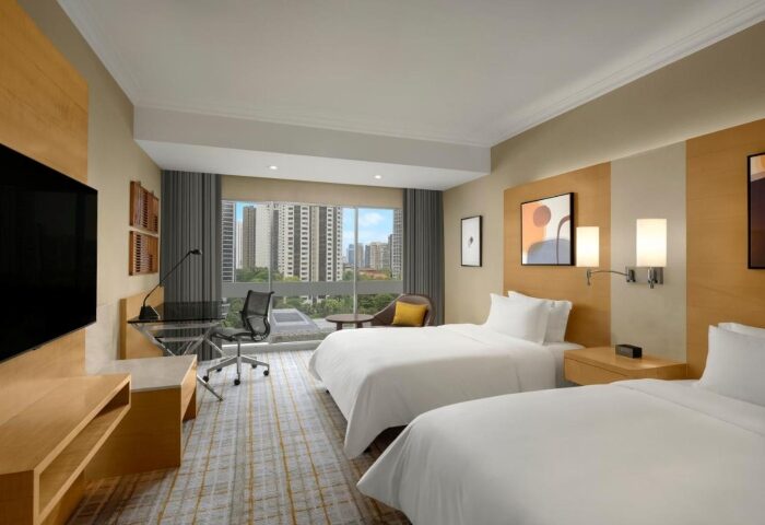 voco Orchard Singapore, an IHG Hotel room for friends. Gay-friendly hotel with twin beds, desk, and city view. Top Singapore hotel for groups.