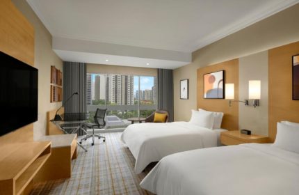 voco Orchard Singapore, an IHG Hotel room for friends. Gay-friendly hotel with twin beds, desk, and city view. Top Singapore hotel for groups.