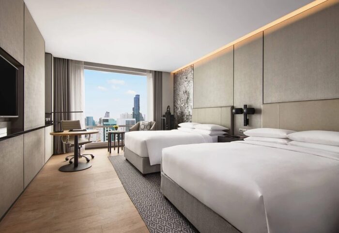 Bangkok Marriott Surawongse Hotel room. Gay-friendly hotel with twin beds, desk, and city view. Top choice for party boys in Bangkok.