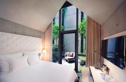 M Social Singapore hotel room with a view of the garden. Top gay honeymoon hotel. Modern design, perfect for a romantic getaway.